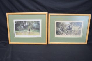 Pair of David Shepherd prints of elephants, signed in pencil to margins, in glazed wood frames -