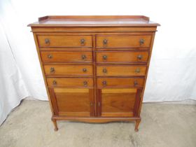 Edwardian mahogany music cabinet having raised back, eight drawers over two panelled cupboard