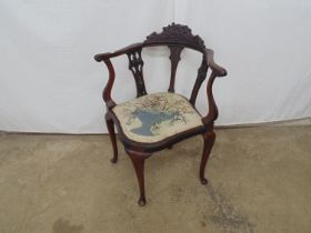 Edwardian mahogany corner chair with carved cresting rail (one piece missing), having a shaped