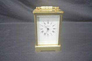 Angelus brass cased carriage clock with top carrying handle, white dial, black Roman Numerals and