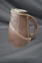 Doulton Lambeth leather effect jug No. 7771 with silver mounted rim, hallmarked for London - 19.