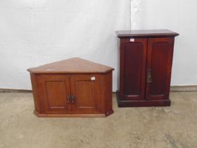 Oak table top cabinet with two panelled doors opening to reveal three fitted shelves, standing on