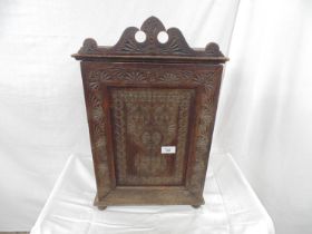 Carved hardwood table top cabinet the hinged carved panelled door opening to two fixed shelves,