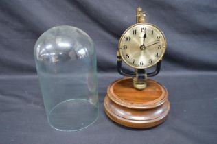 Bulle Electromagnetic 800 day glass domed clock with skeletonised movement, on turned wooden base