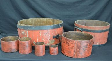 Wood and metal bound two handled bushel and half bushel measures together with some smaller wooden