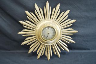 Gilt painted sunburst wall clock with Swiss movement, silvered dial, black Roman Numerals and single