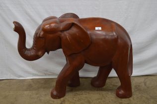 Large carved wooden figure of an elephant with raised trunk - 63cm tall Please note descriptions are