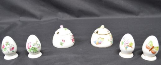 Two Herend three piece cruet sets each comprising: salt, pepper, and mustard pots decorated with