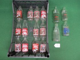 Sixteen glass milk bottles with various Cadbury's Drinking Chocolate advertisements Please note