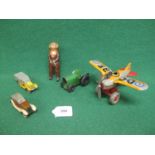 Four clockwork tinplate toys to comprise: a Made In Japan by KT fighter plane whose propeller