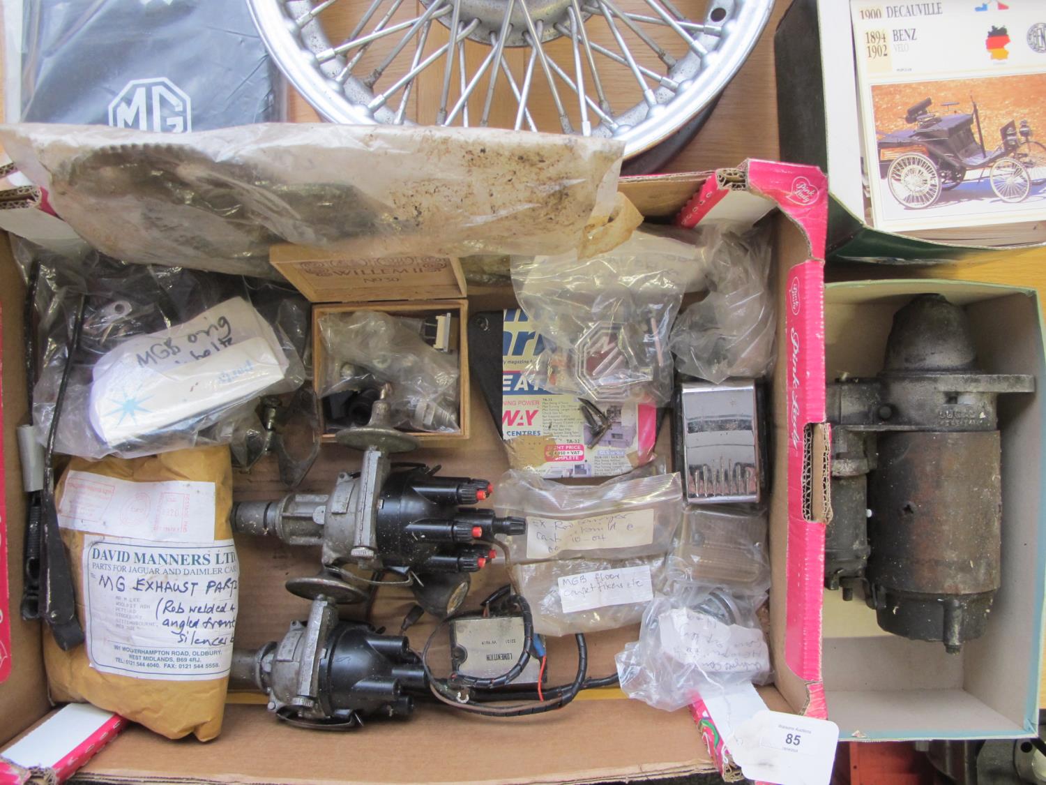 Box of MGB used and unused parts to include: starter motor, new mud flaps, classic car collectors