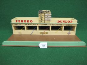 Unbranded but possibly Triang race track pit lane building with refuelling pipes, roof top