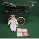 Childs Silver Cross pram finished in lined green and chrome and containing a 1997 porcelain Nicholas