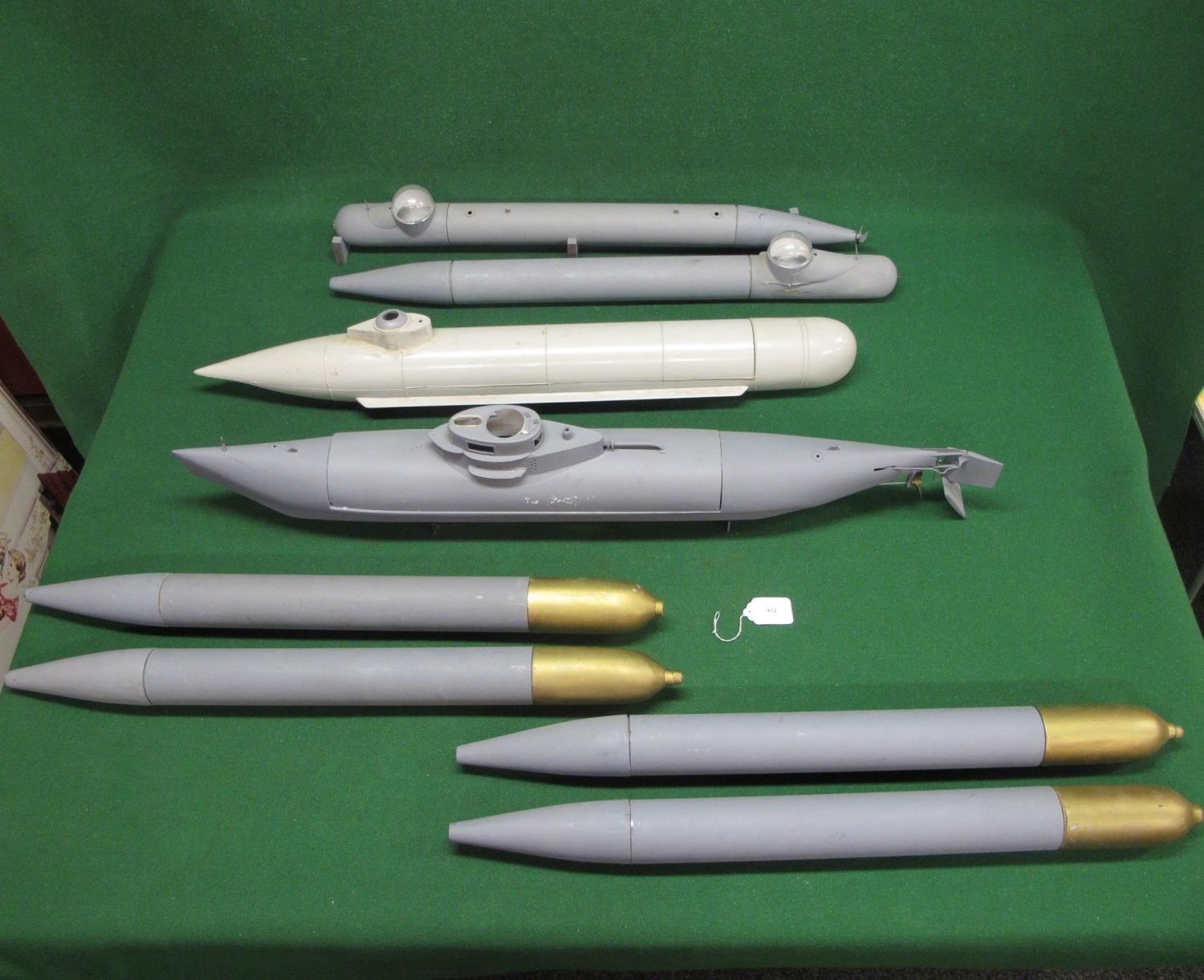 Four large submersible models together with four possibly torpedo models, all of plastic and wood