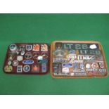 Two trays of metal and plastic vehicle manufacturers badges to include: Ford, Avenger, Golf GTI,