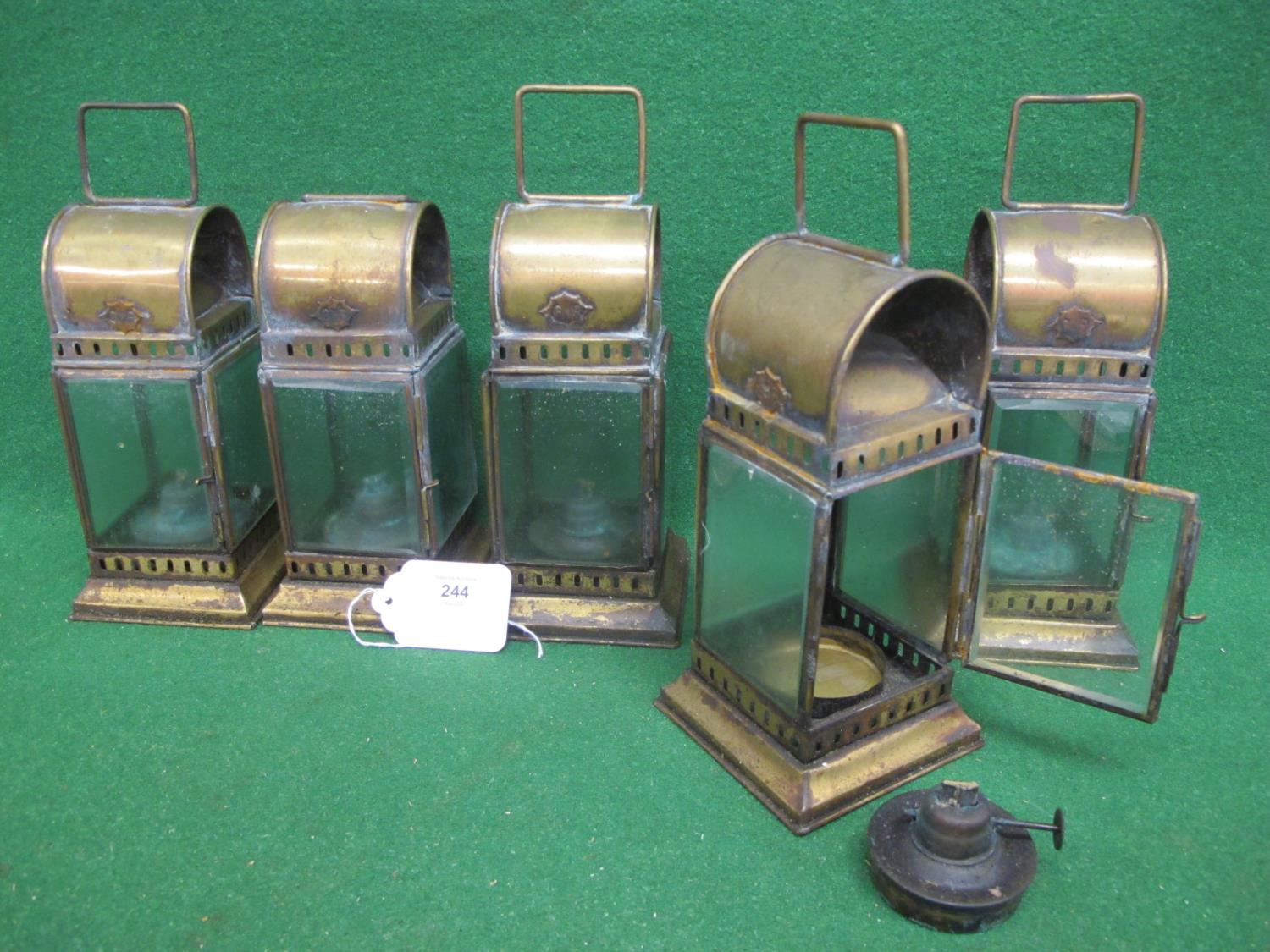 Five square brass lanterns with bevelled glass, paraffin burners and top handles, stamped GWR on