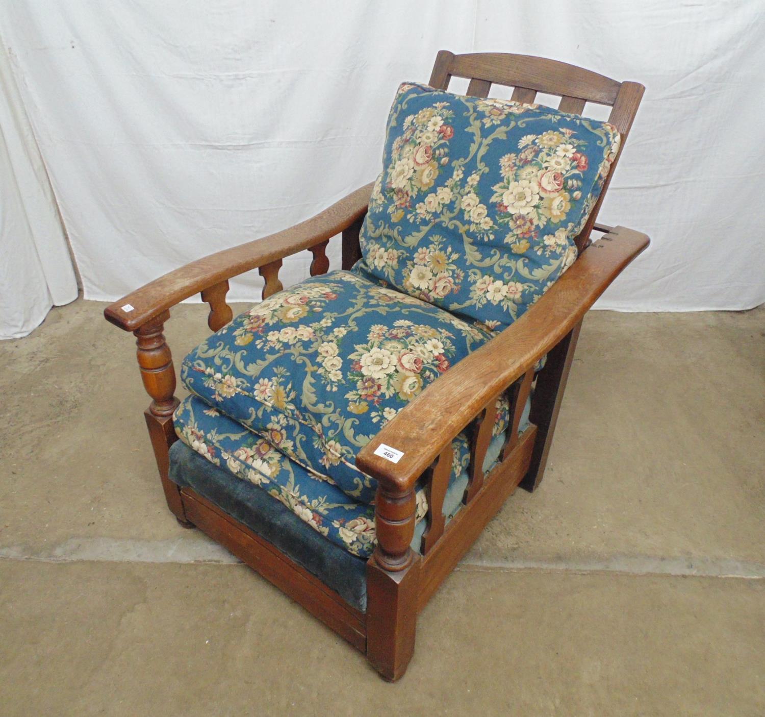 Early 20th century oak armchair having reclining back rail with shaped elbow rests, slatted sides