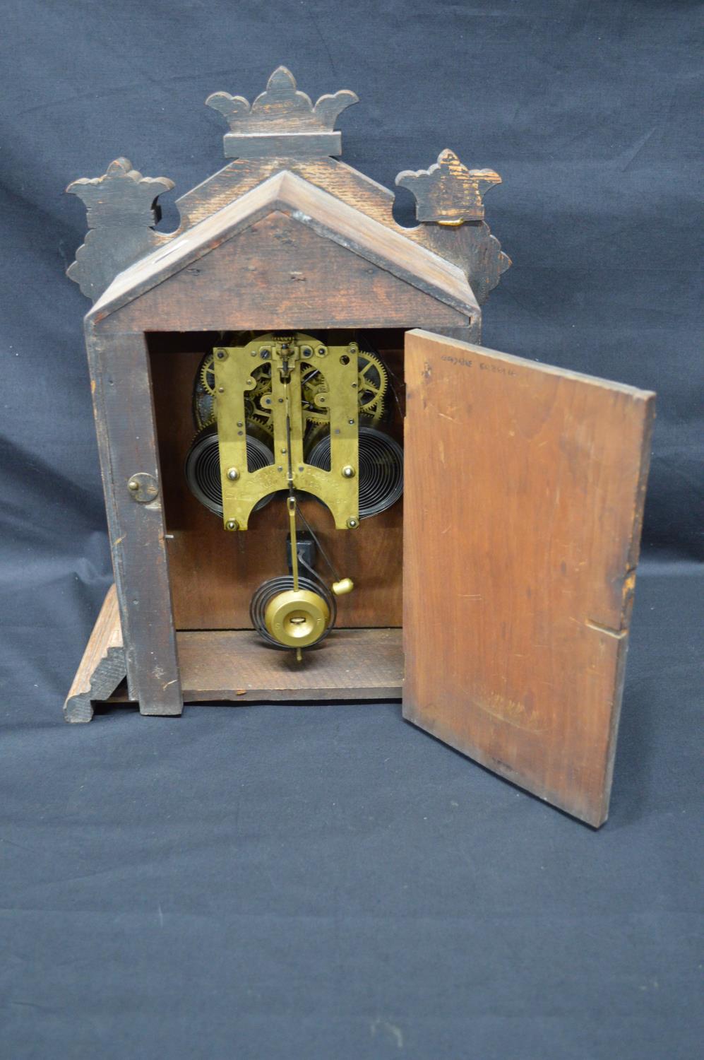 Oak cased mantle clock having some carving to case and standing on stepped base. Black hands and - Image 4 of 5