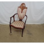 Art Nouveau mahogany elbow chair having inlaid arched cresting rail with padded back and seat,