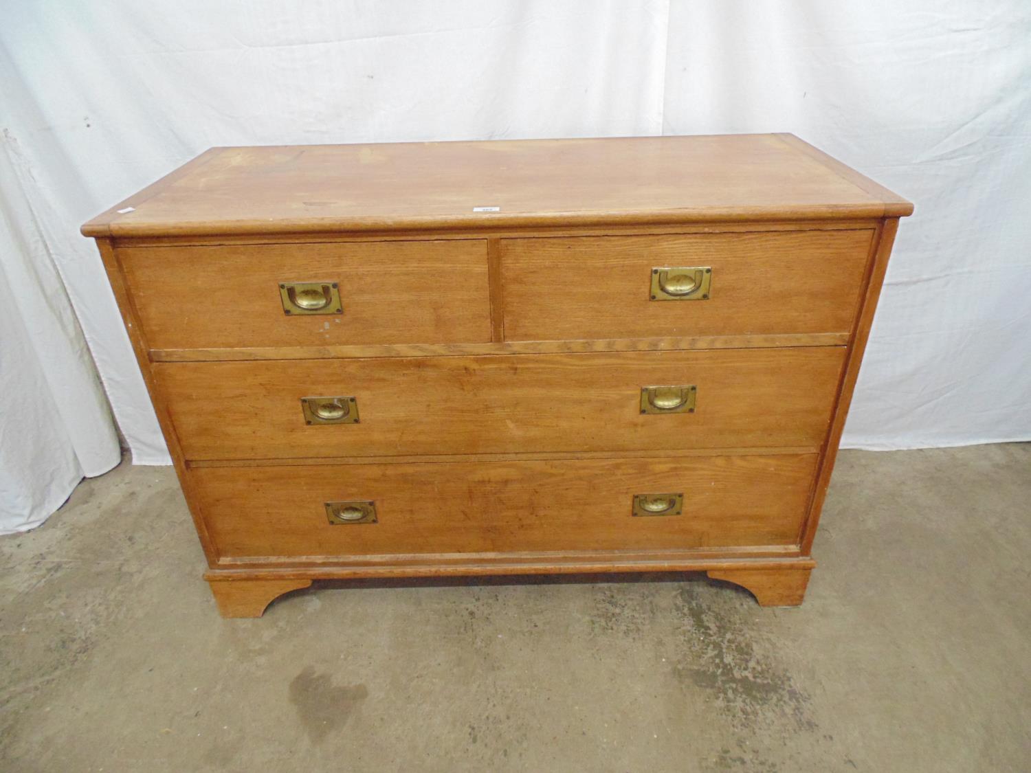 Light oak chest of two short and two long drawers with military style handles, standing on bracket