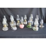 Group of thirteen glass chamber oil lamps Please note descriptions are not condition reports, please