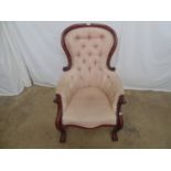 Victorian mahogany framed armchair with buttoned back and arms, pink upholstery, standing on