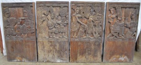 Set of four carved hardwood possibly African panels each decorated with figures and numbered in