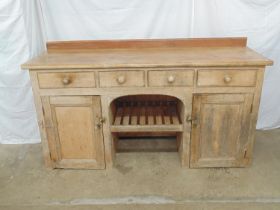 Victorian pine dresser base having raised back over four drawers with open arched centre, the