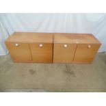 Pair of mid century teak cupboards the two door opening to a single fixed shelf, standing on