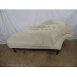 Chaise longue in cream upholstery with button back and side, standing on turned legs ending in