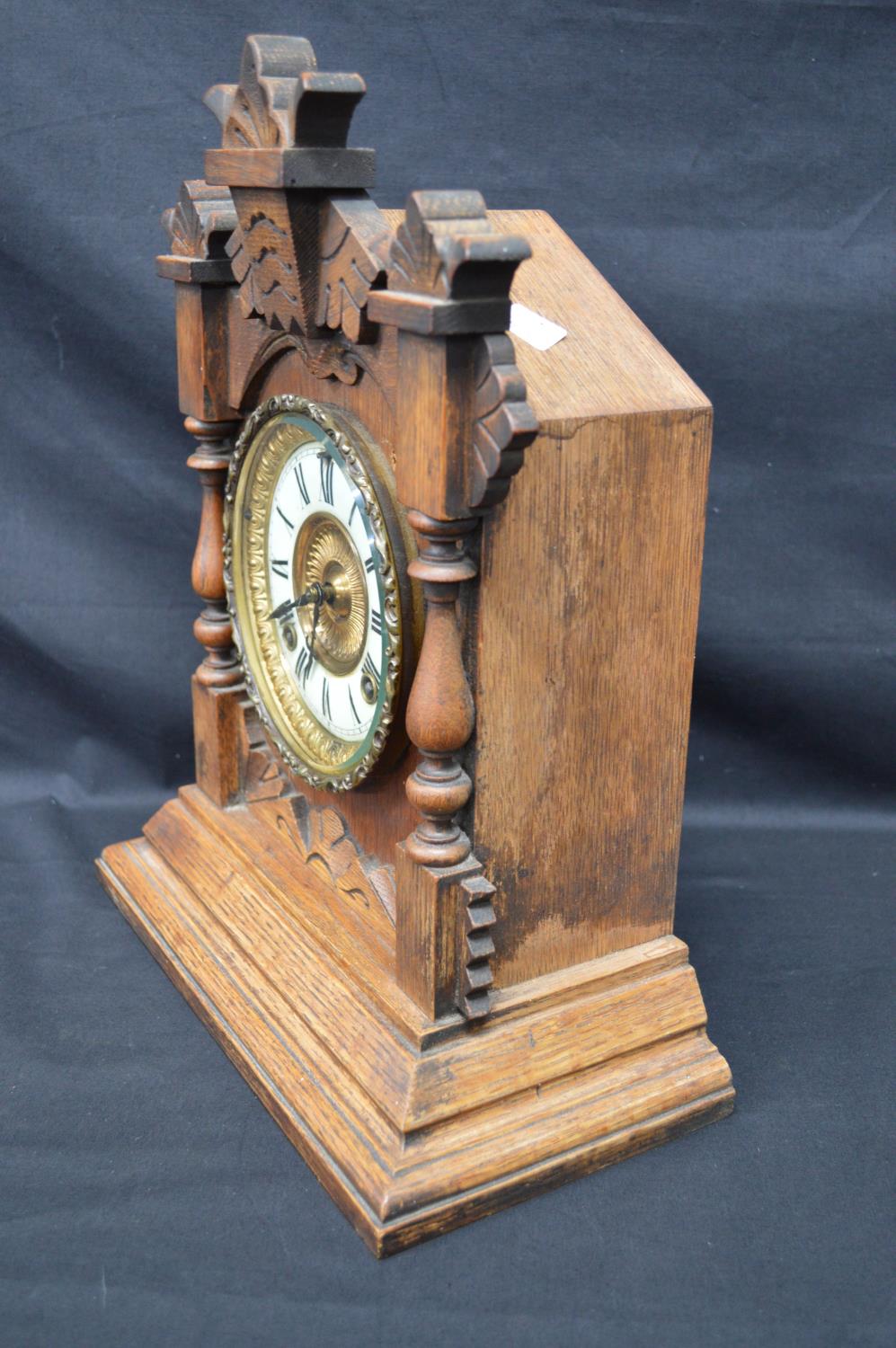 Oak cased mantle clock having some carving to case and standing on stepped base. Black hands and - Image 2 of 5