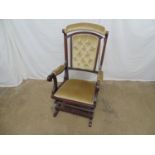 Mahogany button back spring rocking chair having padded cresting rail, back, arms and seat with