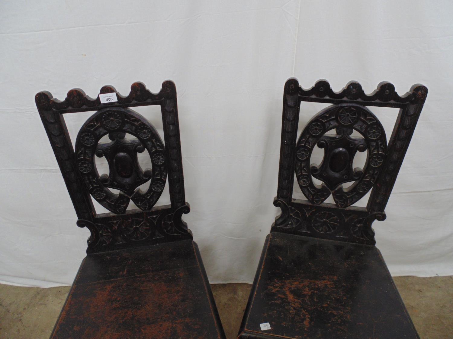 Pair of oak hall chairs having carved backs, solid seats and turned front legs - 42cm x 38cm x - Image 2 of 4