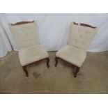 Pair of modern button back bedroom chairs both having a carved cresting rail, padded seat and