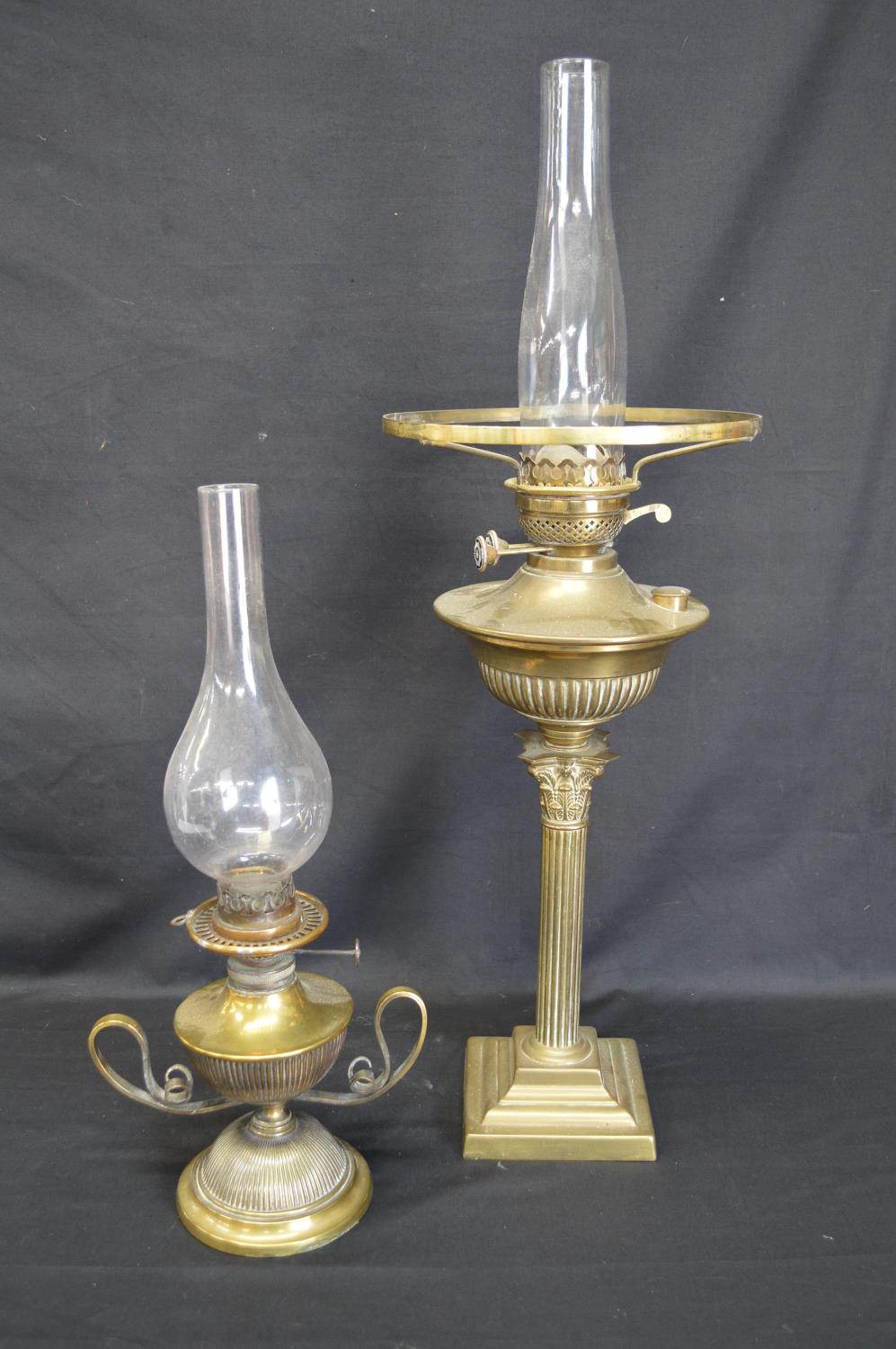 Two brass oil lamps with chimneys - tallest 69cm including chimney Please note descriptions are