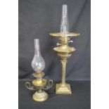 Two brass oil lamps with chimneys - tallest 69cm including chimney Please note descriptions are