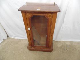 Inlaid mahogany music cabinet having raised back to back over single glazed door enclosing two