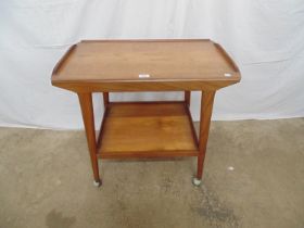 Mid century teak two tier tea trolley both tiers having raised gallery, standing on tapering legs