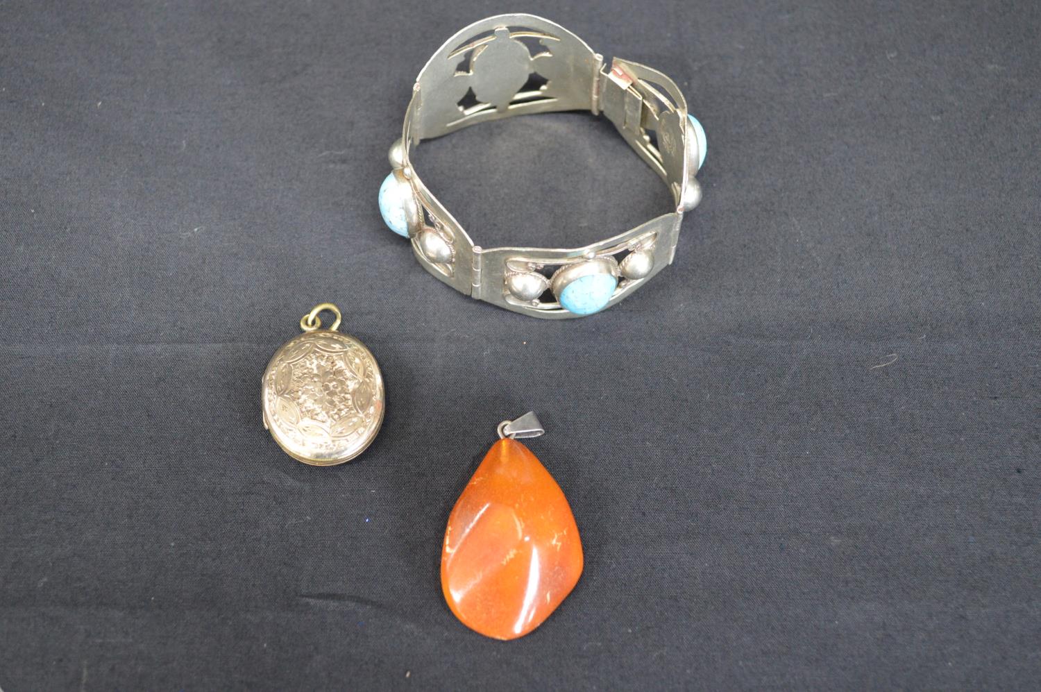 Three pieces of jewellery to comprise: Mexican white metal bracelet, yellow metal locket and amber