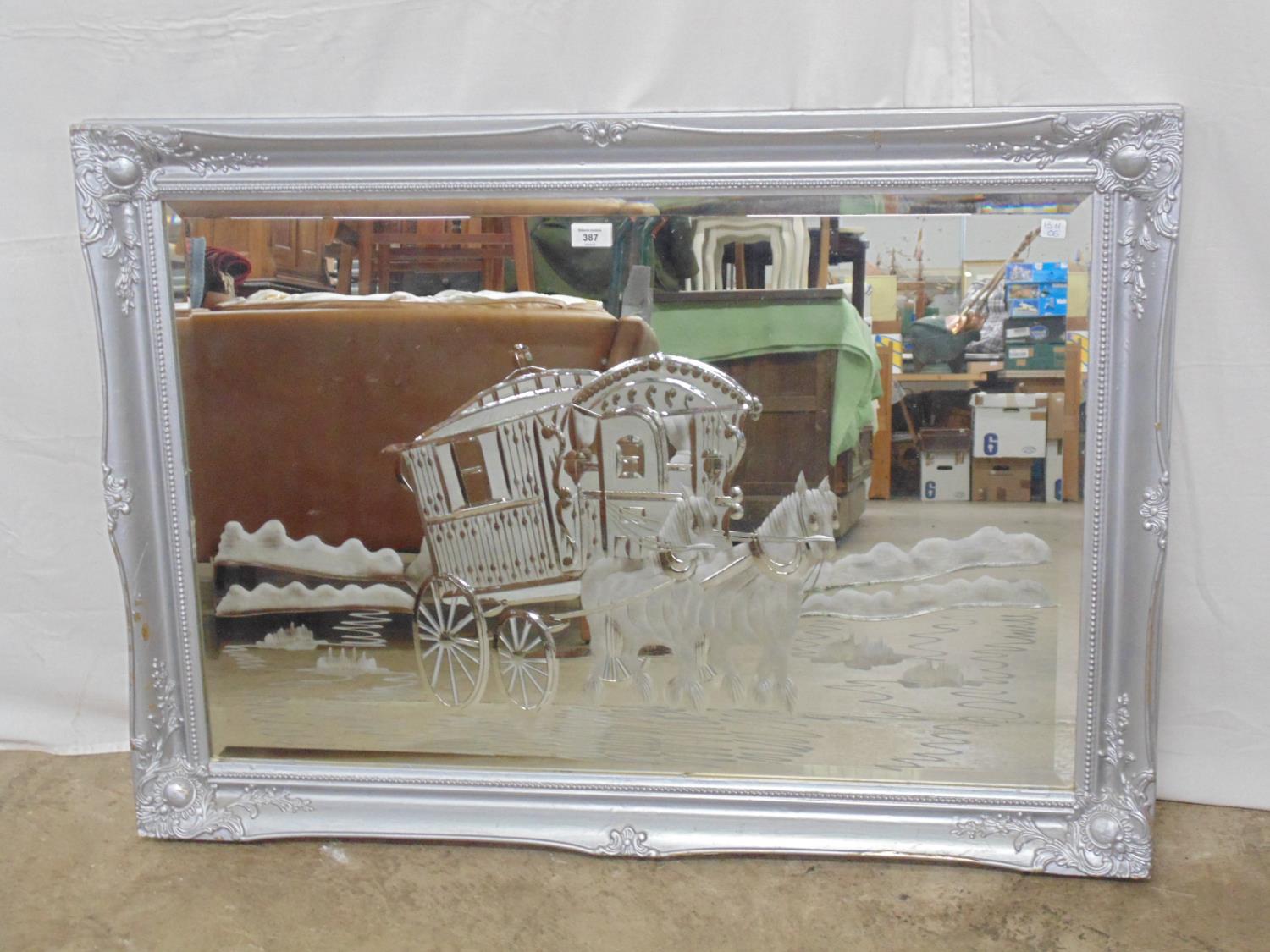 Bevel edge etched mirror with scene of a gypsy caravan being pulled by two horses, in painted silver