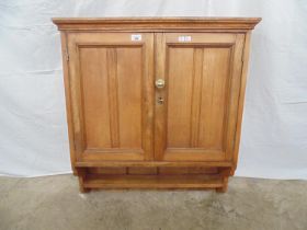 Oak wall cupboard having two moulded panelled doors opening to reveal a single fixed shelf with