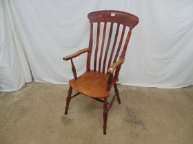 Elm and beech Windsor chair having slat back and standing on turned legs with cross stretchers -