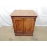 Oak cupboard having two panelled doors opening to reveal single fitted shelf, brushing slide and
