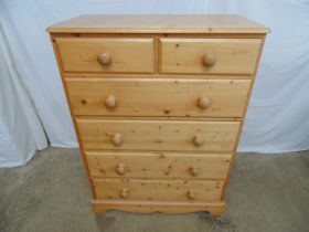 Modern pine chest of two short over four long drawers, standing on plinth base with shaped front