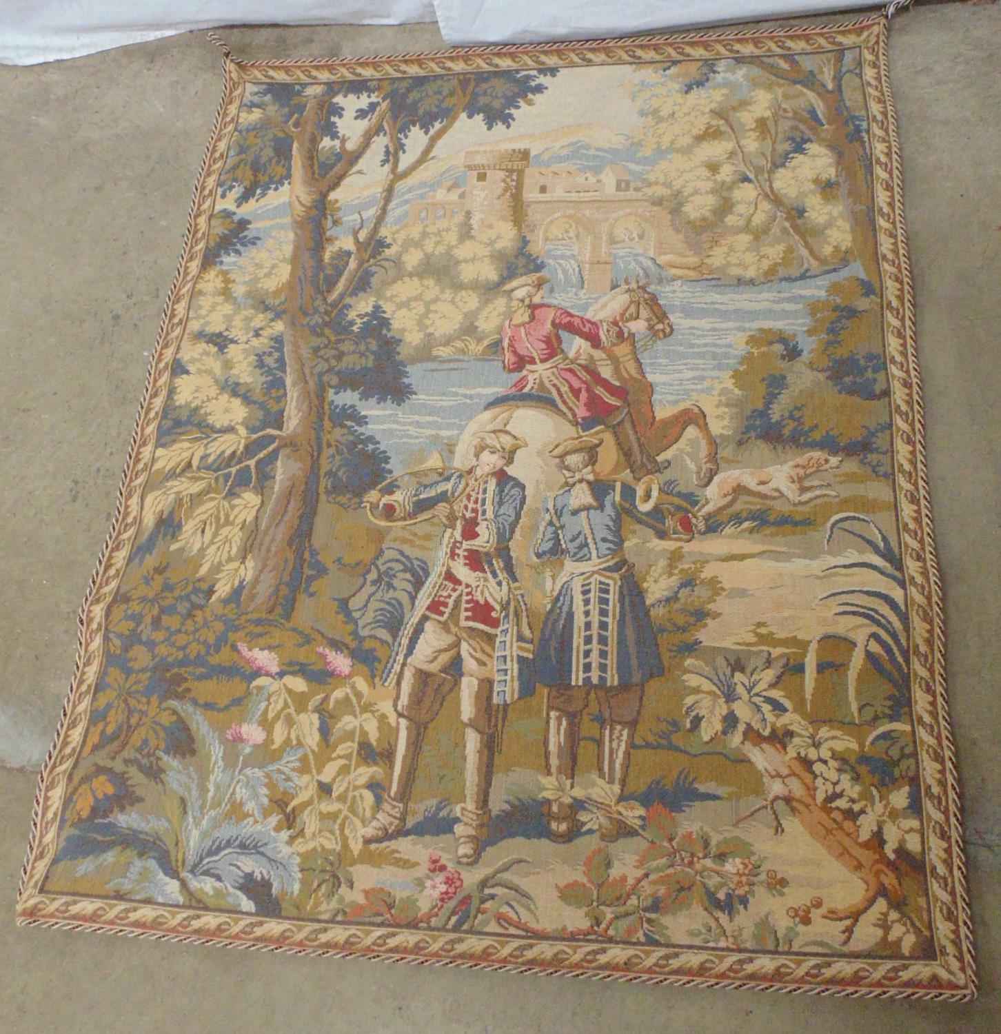 Wall hanging of gentleman on horseback approaching a castle - 124cm x 91cm together with one other