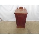 Mahogany pot cupboard with raised back having single panelled door opening to reveal single shelf,