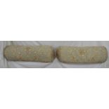 Pair of bolster cushions in grey and cream upholstery, believed to be from the Dorchester Hotel -