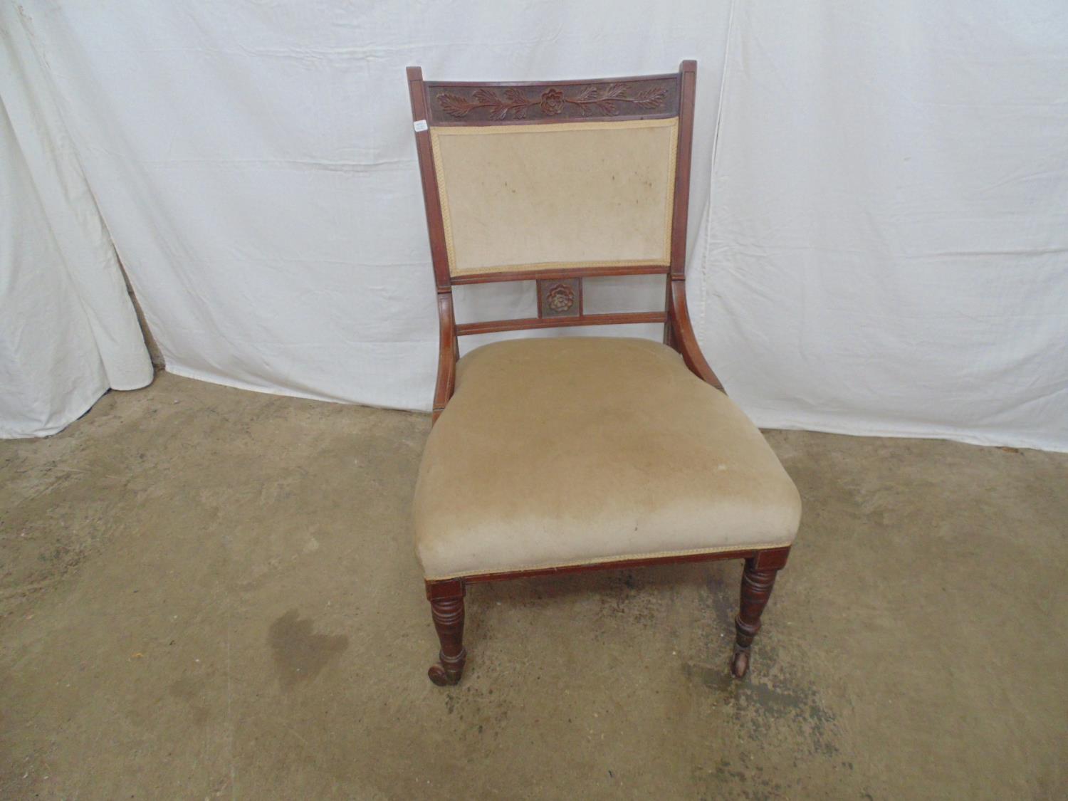 Mahogany bedroom chair with carved cresting rail, padded back and seat, standing on turned front