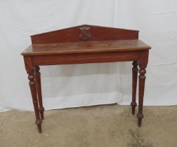 Late 19th/early 20th century oak hall/side table having raised back with central carved shield