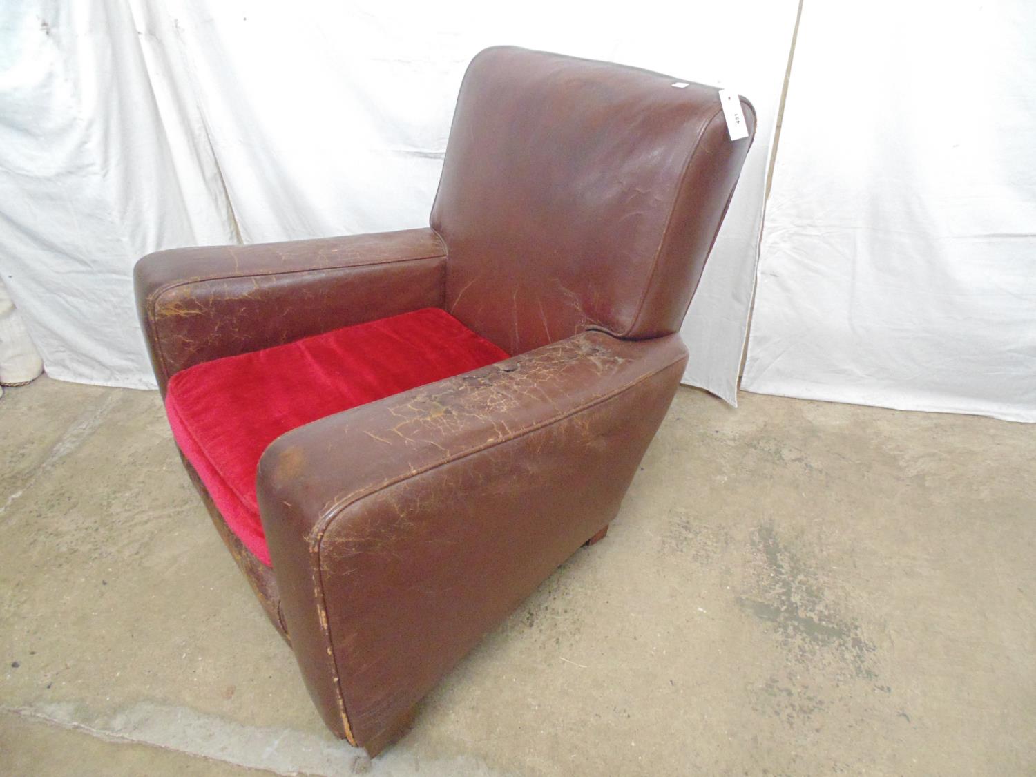 Brown leather club chair with red cushion, standing on block feet and castors (af) - 84cm x 72cm x - Image 4 of 5